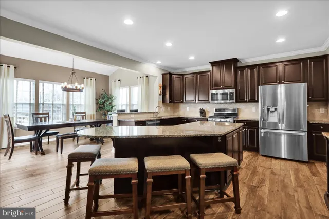a view of a workspace with furniture and wooden floor