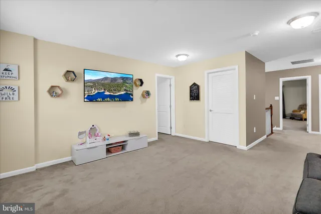 a living room with furniture and a kitchen view