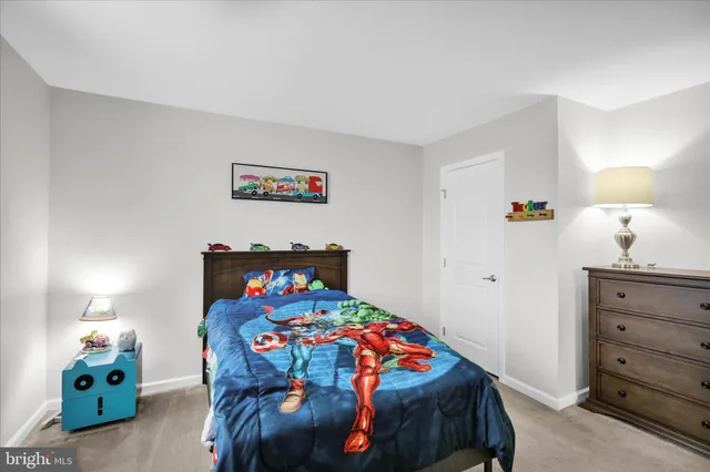 a hallway with a chairs and a potted plant