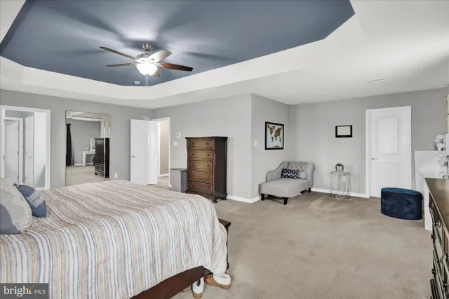 a view of a house next to a big yard with potted plants