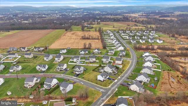a aerial view of a house with swimming pool lawn chairs and a yard