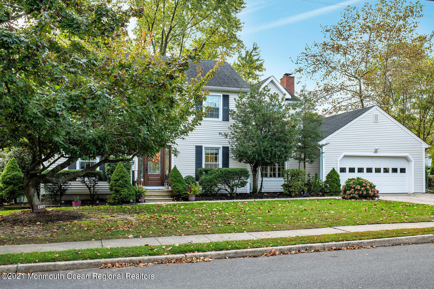 1207 Wall Road Spring Lake Heights, NJ 07762 - Photo 1 of 37 a front view of a house with a yard and a garage