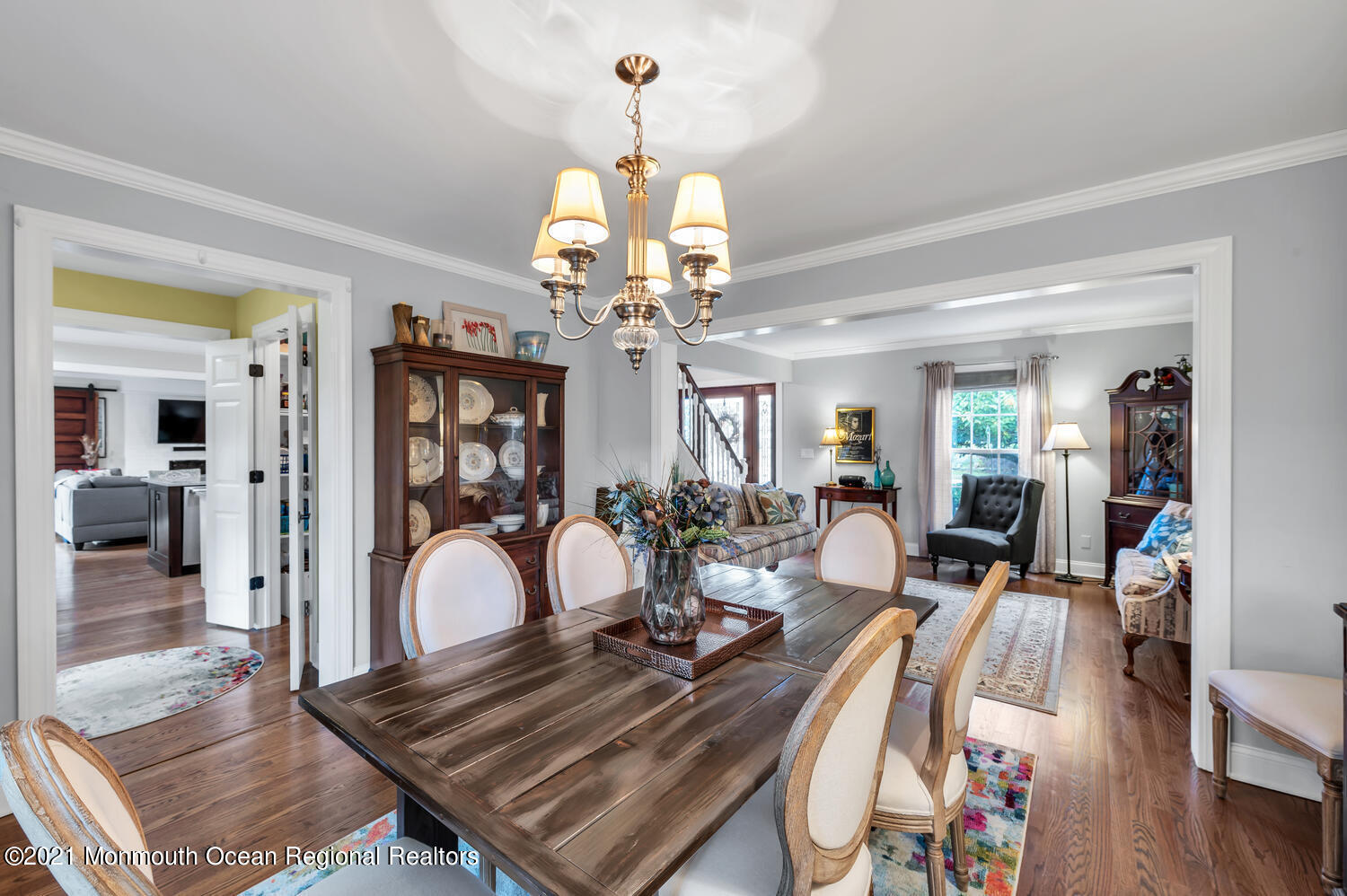 1207 Wall Road Spring Lake Heights, NJ 07762 - Photo 4 of 37 a view of a dining room and livingroom with furniture wooden floor a chandelier