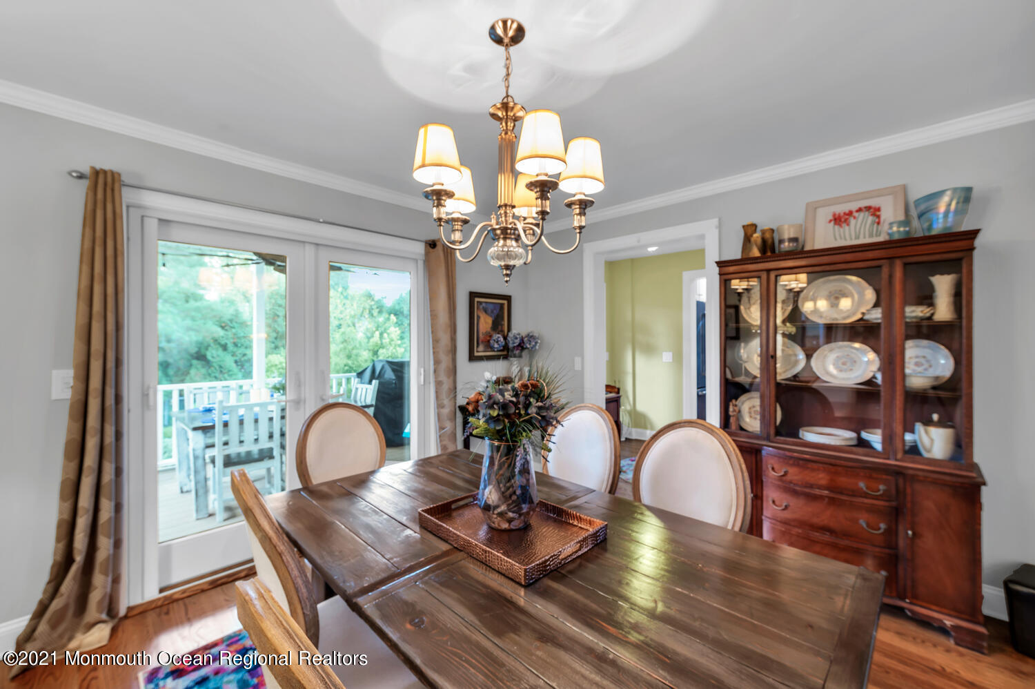 1207 Wall Road Spring Lake Heights, NJ 07762 - Photo 5 of 37 a view of a dining room with furniture wooden floor and a chandelier