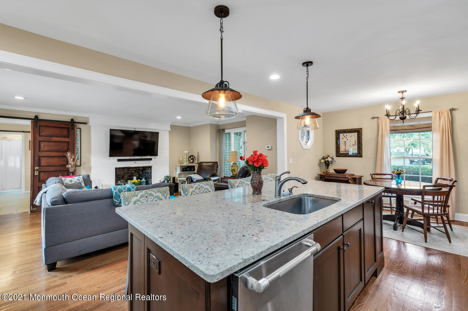 1207 Wall Road Spring Lake Heights, NJ 07762 - Photo 10 of 37 a kitchen with granite countertop a table chairs in it and wooden floors