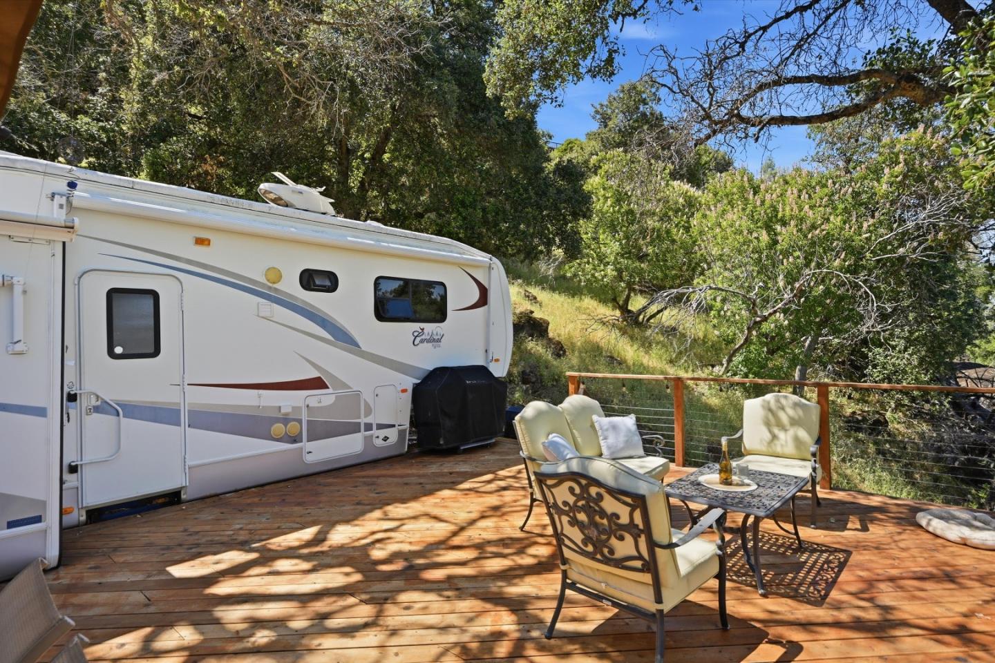 5156 Lake Road Lower Lake, CA 95457 - Photo 15 of 27 a view of a patio with table and chairs with wooden fence and large trees