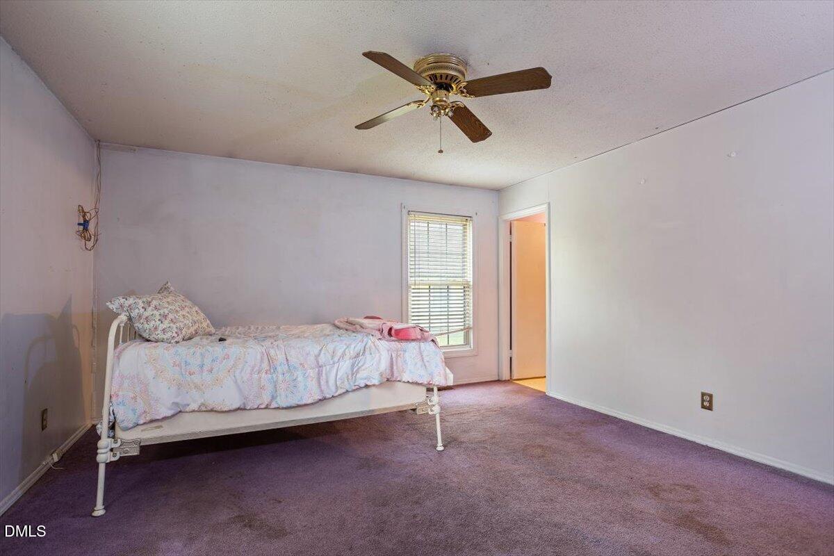 1600 Cranston Road Garner, NC 27529 - Photo 12 of 25 a bed room with a bed and a window