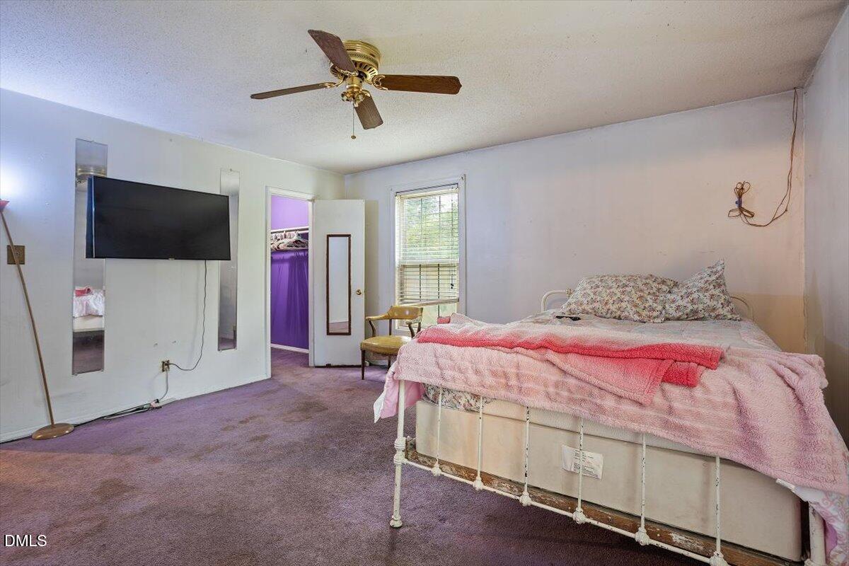1600 Cranston Road Garner, NC 27529 - Photo 13 of 25 a bedroom with a bed and a flat screen tv