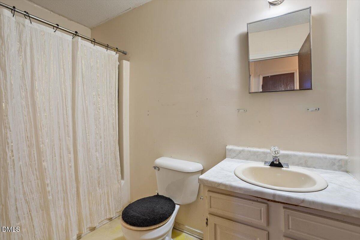 1600 Cranston Road Garner, NC 27529 - Photo 17 of 25 a bathroom with a sink a toilet and a mirror