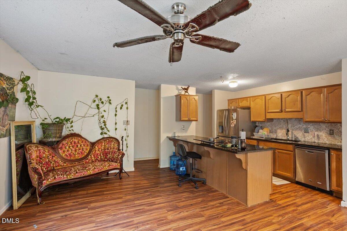 1600 Cranston Road Garner, NC 27529 - Photo 22 of 25 a kitchen with stainless steel appliances granite countertop a sink and cabinets
