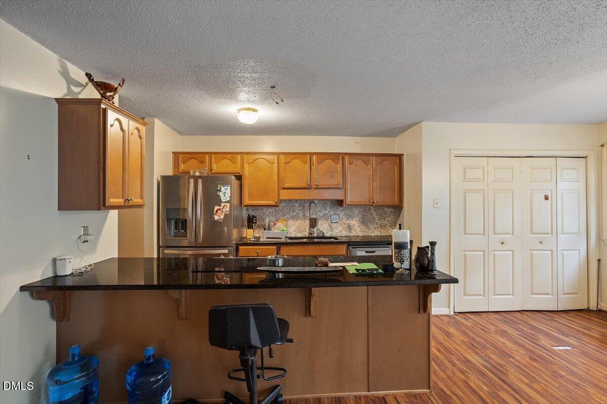 1600 Cranston Road Garner, NC 27529 - Photo 23 of 25 a kitchen with stainless steel appliances granite countertop a sink and cabinets