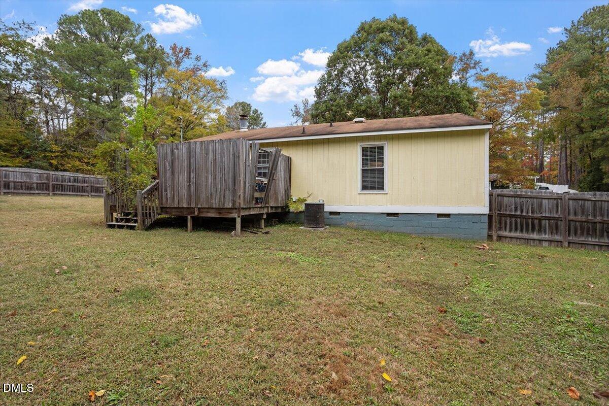 1600 Cranston Road Garner, NC 27529 - Photo 3 of 25 a backyard of a house with barbeque oven and wooden fence