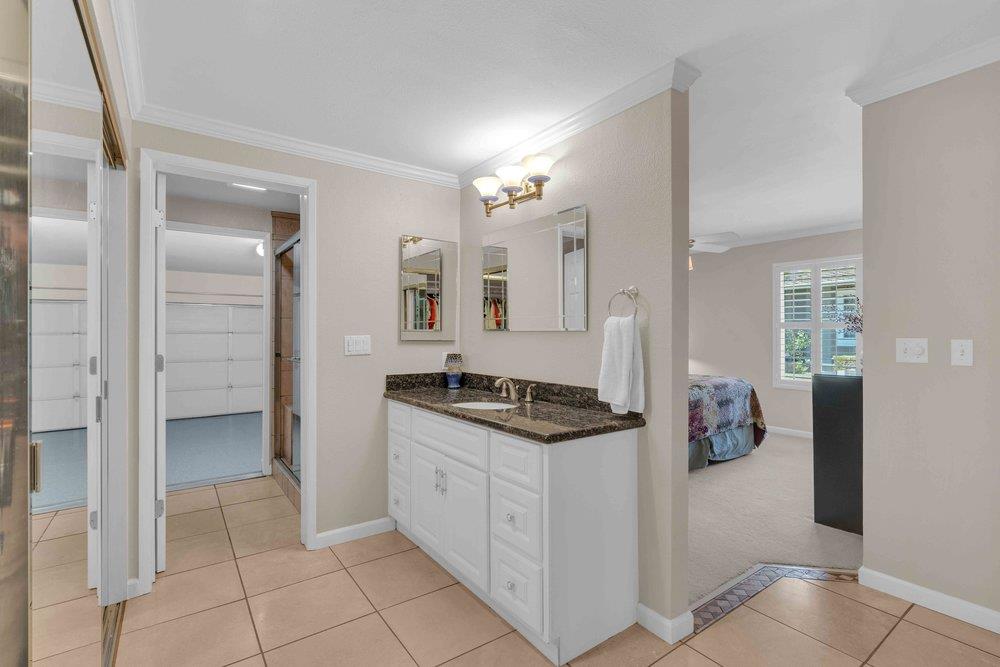 1854 St George Road Danville, CA 94526 - Photo 11 of 47 a bathroom with a granite countertop sink a mirror and a shower