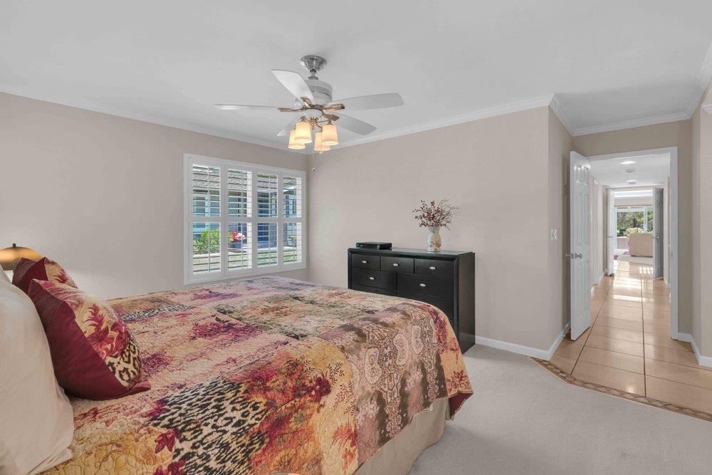 1854 St George Road Danville, CA 94526 - Photo 14 of 47 a bedroom with a large bed and a chandelier
