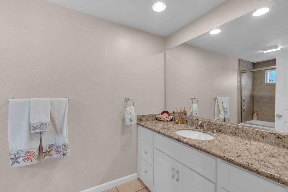 1854 St George Road Danville, CA 94526 - Photo 17 of 47 a bathroom with a granite countertop sink and a mirror