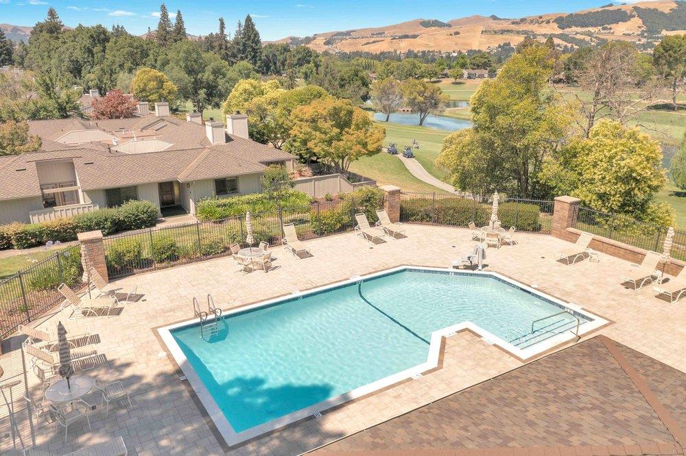 1854 St George Road Danville, CA 94526 - Photo 33 of 47 a view of a pool with a lawn chairs under an umbrella