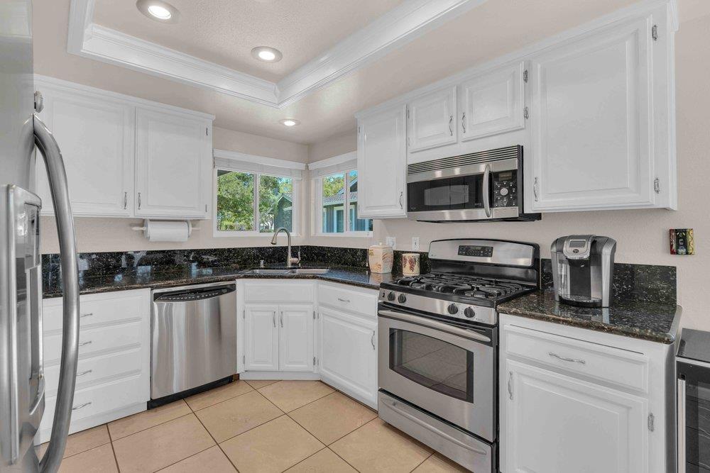 1854 St George Road Danville, CA 94526 - Photo 6 of 47 a kitchen with stainless steel appliances granite countertop a stove sink microwave and cabinets