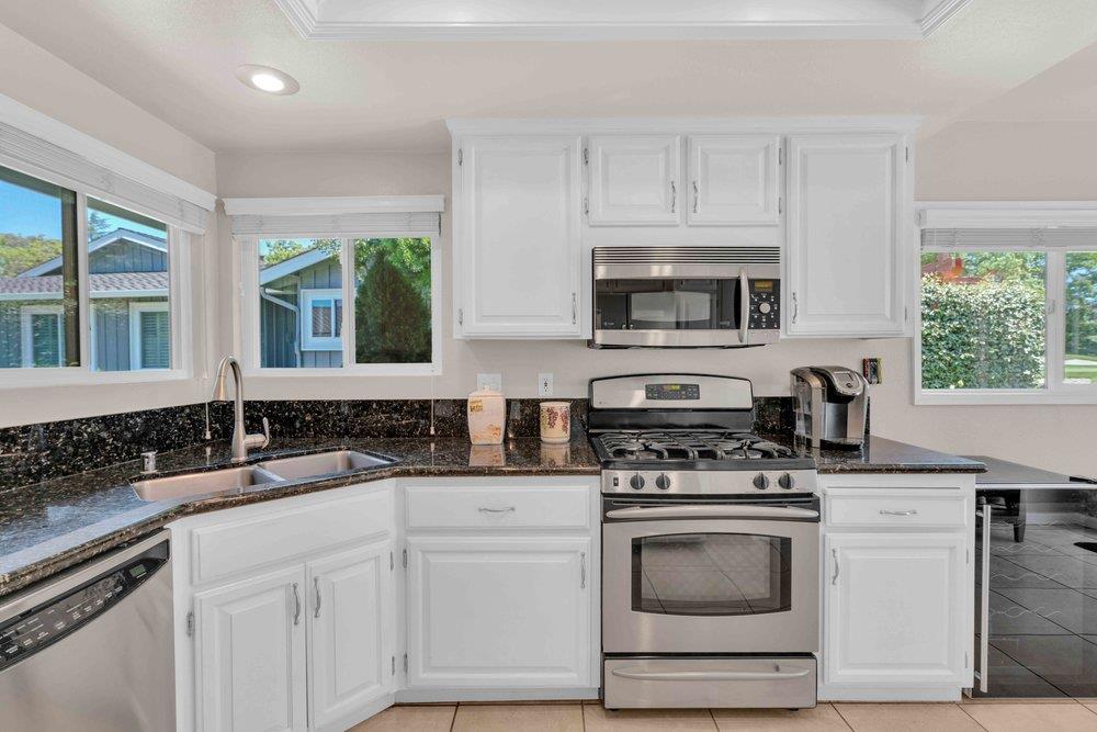 1854 St George Road Danville, CA 94526 - Photo 7 of 47 a kitchen with white cabinets and appliances