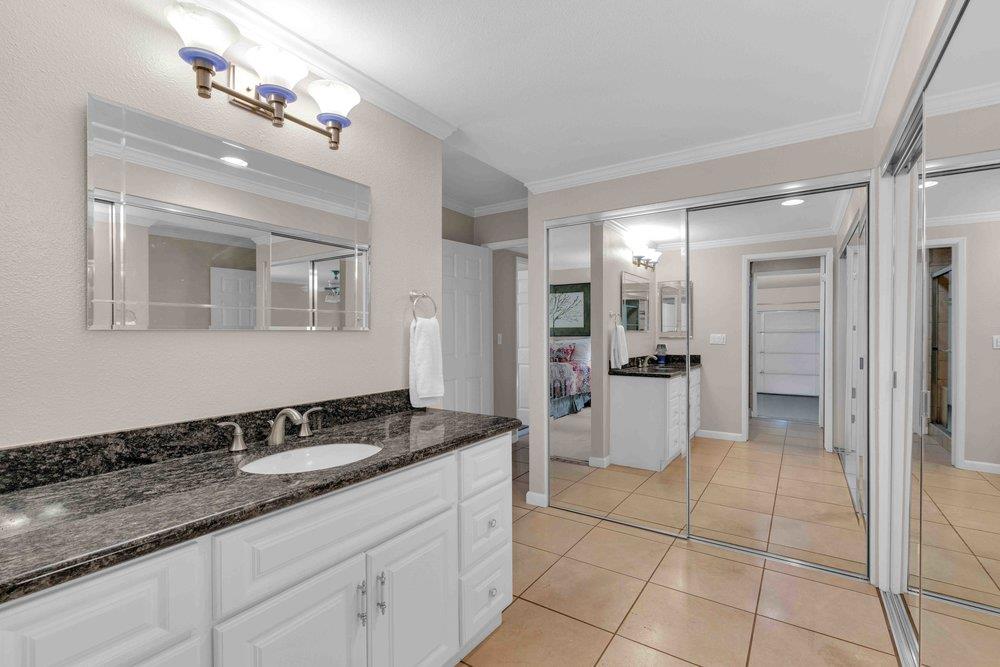 1854 St George Road Danville, CA 94526 - Photo 9 of 47 a bathroom with a granite countertop sink a mirror and a shower