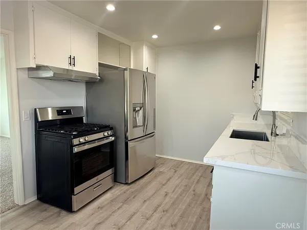 a kitchen with stainless steel appliances a refrigerator and a stove