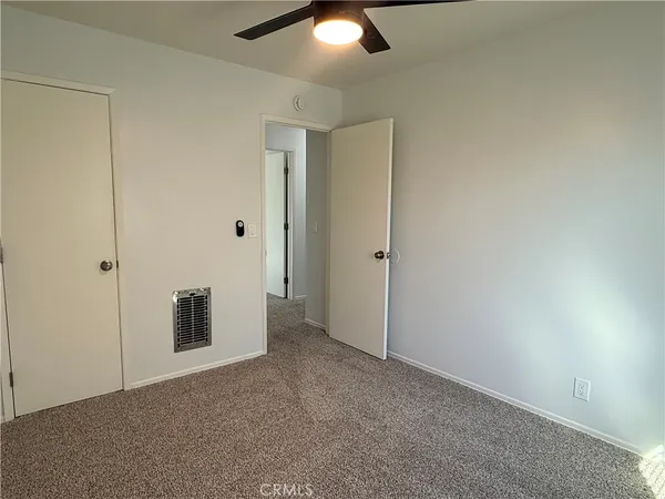 an empty room with closet area