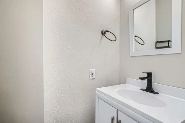 a bathroom with a sink and mirror