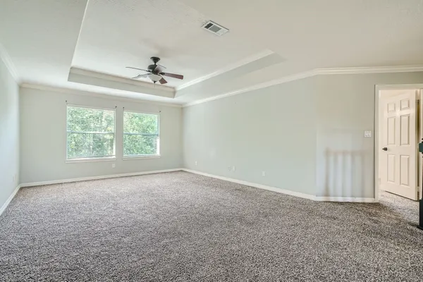 a view of an empty room and kitchen view