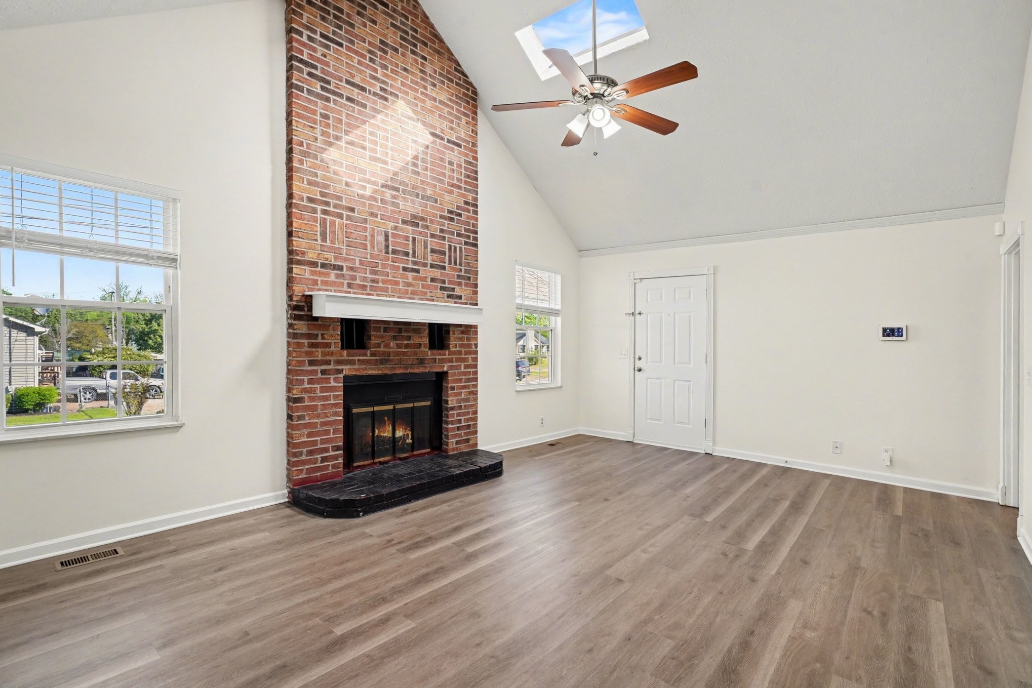 3112 Country Way Road Antioch, TN 37013 - Photo 6 of 19 an empty room with windows fireplace and wooden floor