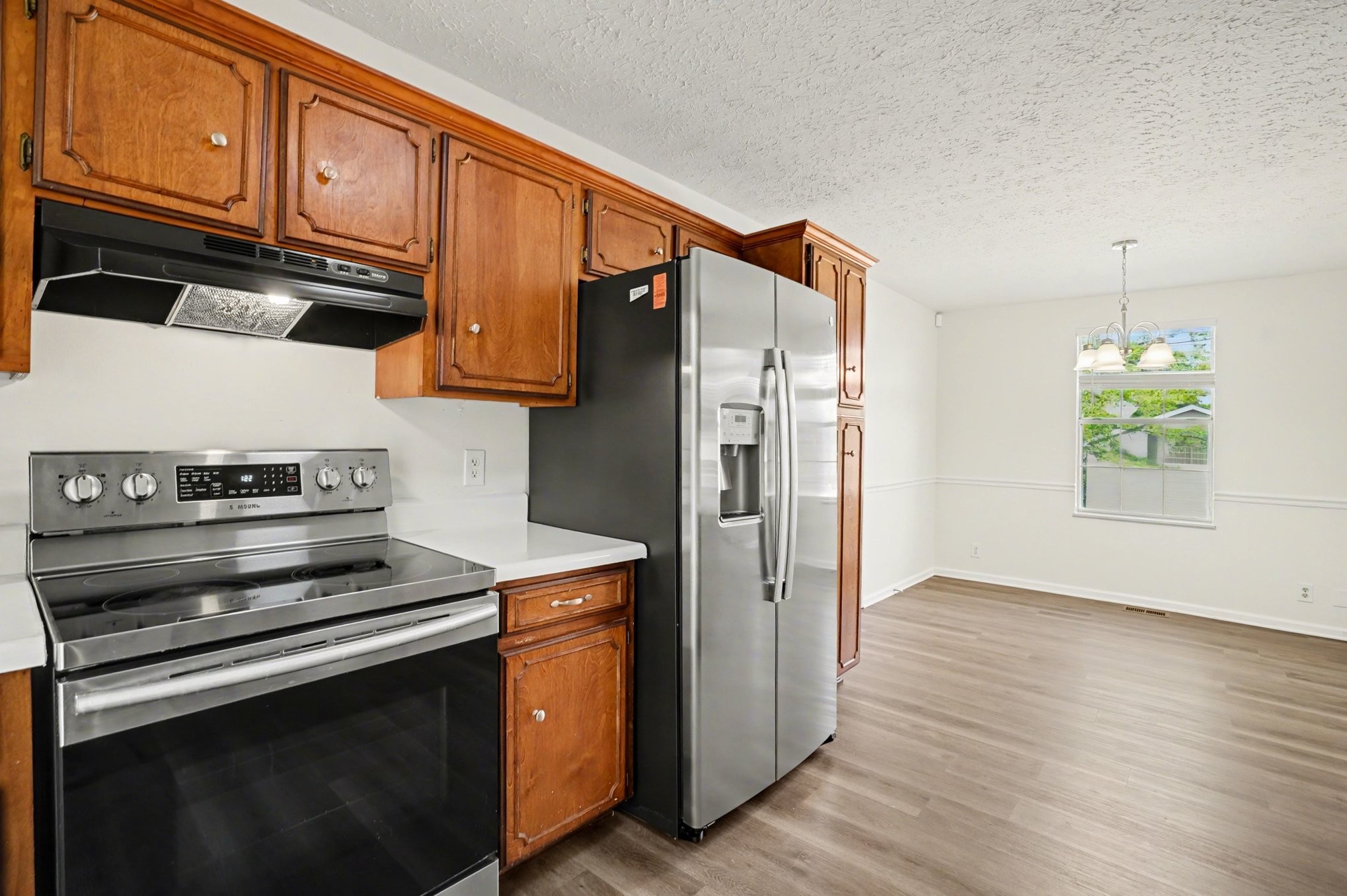 3112 Country Way Road Antioch, TN 37013 - Photo 8 of 19 a kitchen with stainless steel appliances granite countertop a refrigerator stove and wooden cabinets