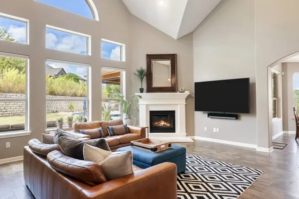 a living room with furniture a flat screen tv and a fireplace
