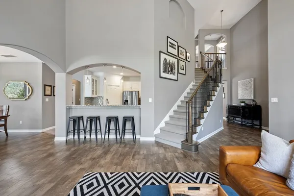a living room with furniture and a dining table