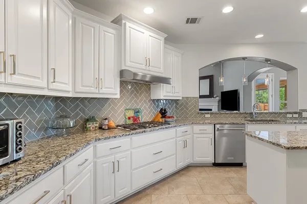 a kitchen with white cabinets and a sink