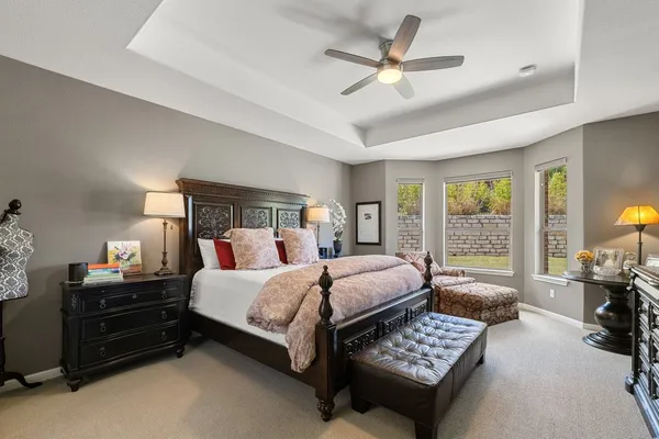 a bedroom with a bed a couch and a window