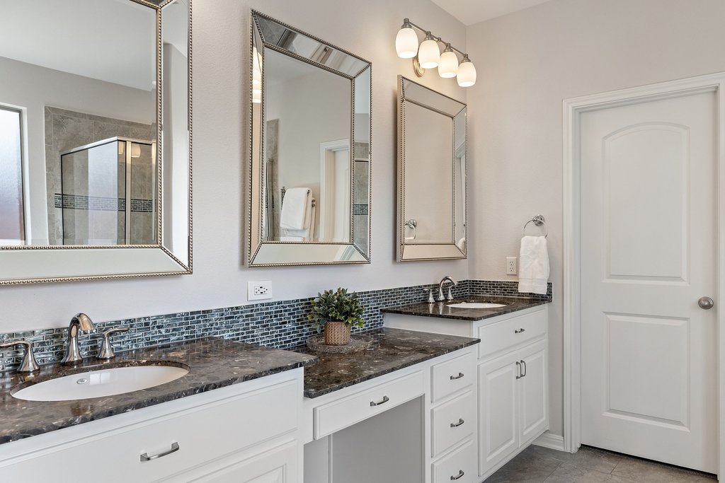 12333 Labrador Bay Court Austin, TX 78732 - Photo 20 of 40 a bathroom with double sink and a mirror