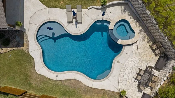 a view of a swimming pool with sitting area