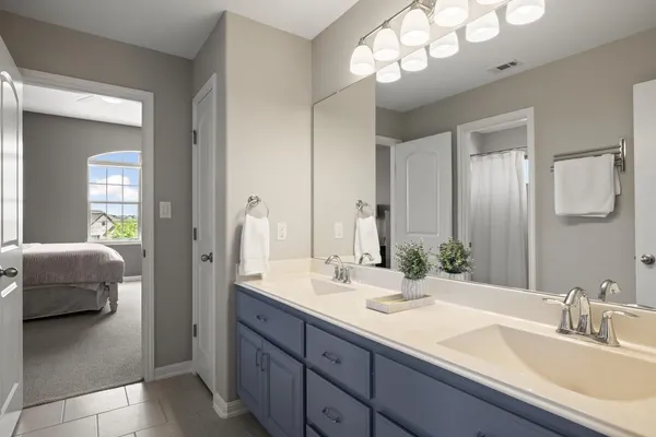 a bathroom with a sink double vanity and a mirror