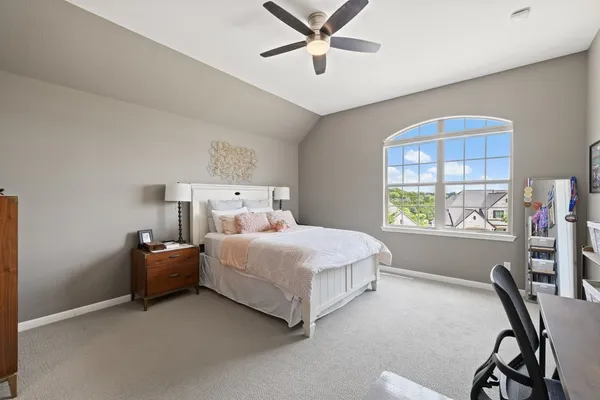 a bedroom with a bed and a desk