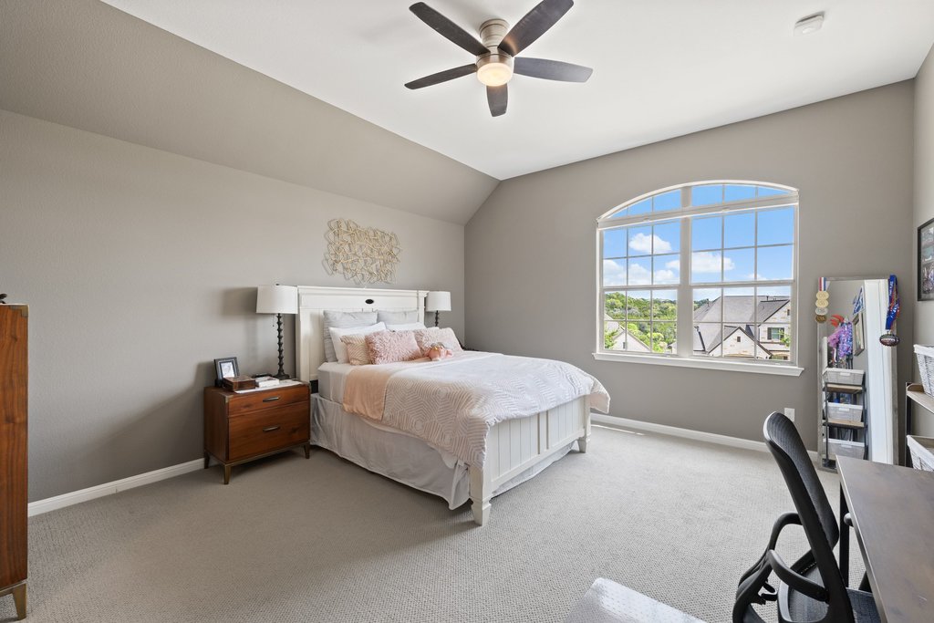 12333 Labrador Bay Court Austin, TX 78732 - Photo 26 of 40 a bedroom with a bed and a desk