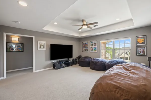 a bedroom with bed tv and window