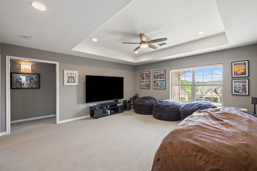 12333 Labrador Bay Court Austin, TX 78732 - Photo 30 of 40 a bedroom with bed tv and window