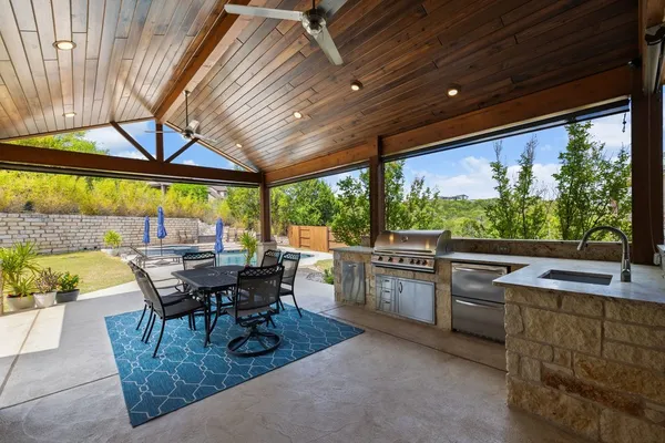a dining room with furniture and a floor to ceiling window