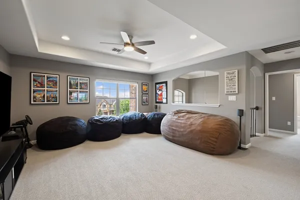 a bedroom with a bed couch and window