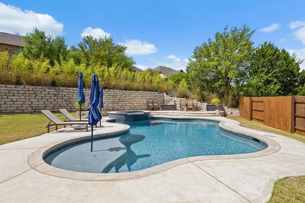 a view of a swimming pool with a patio