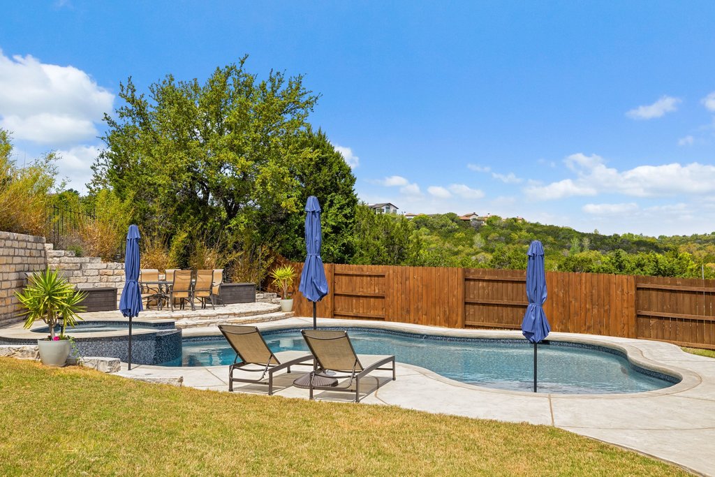 12333 Labrador Bay Court Austin, TX 78732 - Photo 35 of 40 a view of a swimming pool with a lounge chair