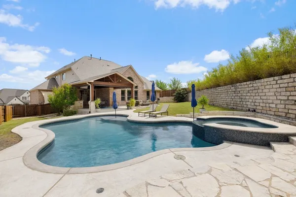 a view of a house with swimming pool and sitting area