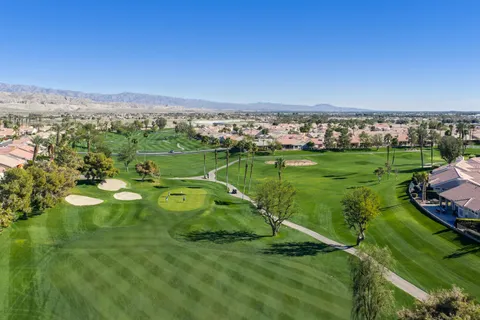 an aerial view of a house with yard and furniture