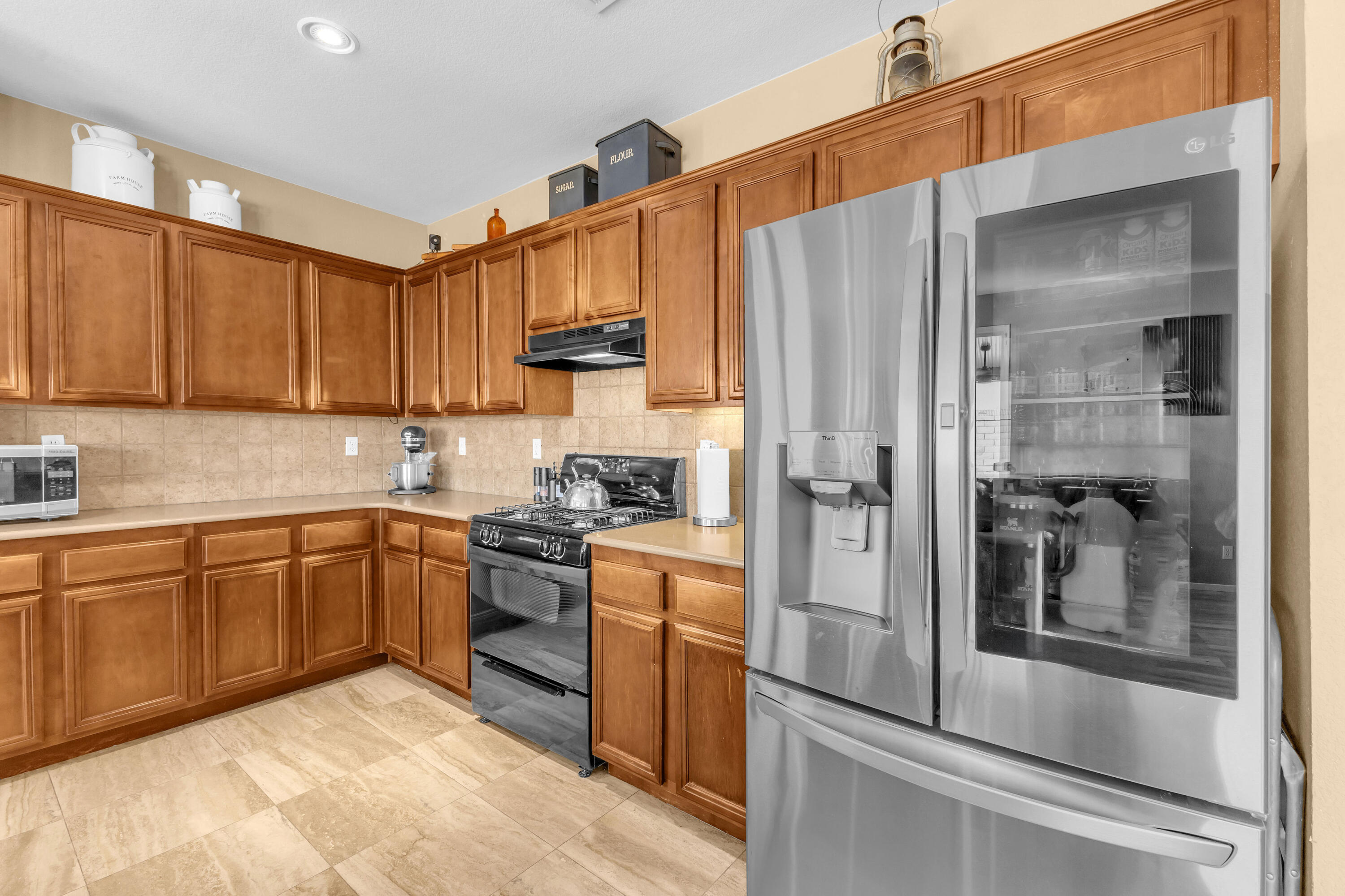41394 Hanover Street Indio, CA 92203 - Photo 13 of 49 a kitchen with stainless steel appliances granite countertop a refrigerator and a stove top oven