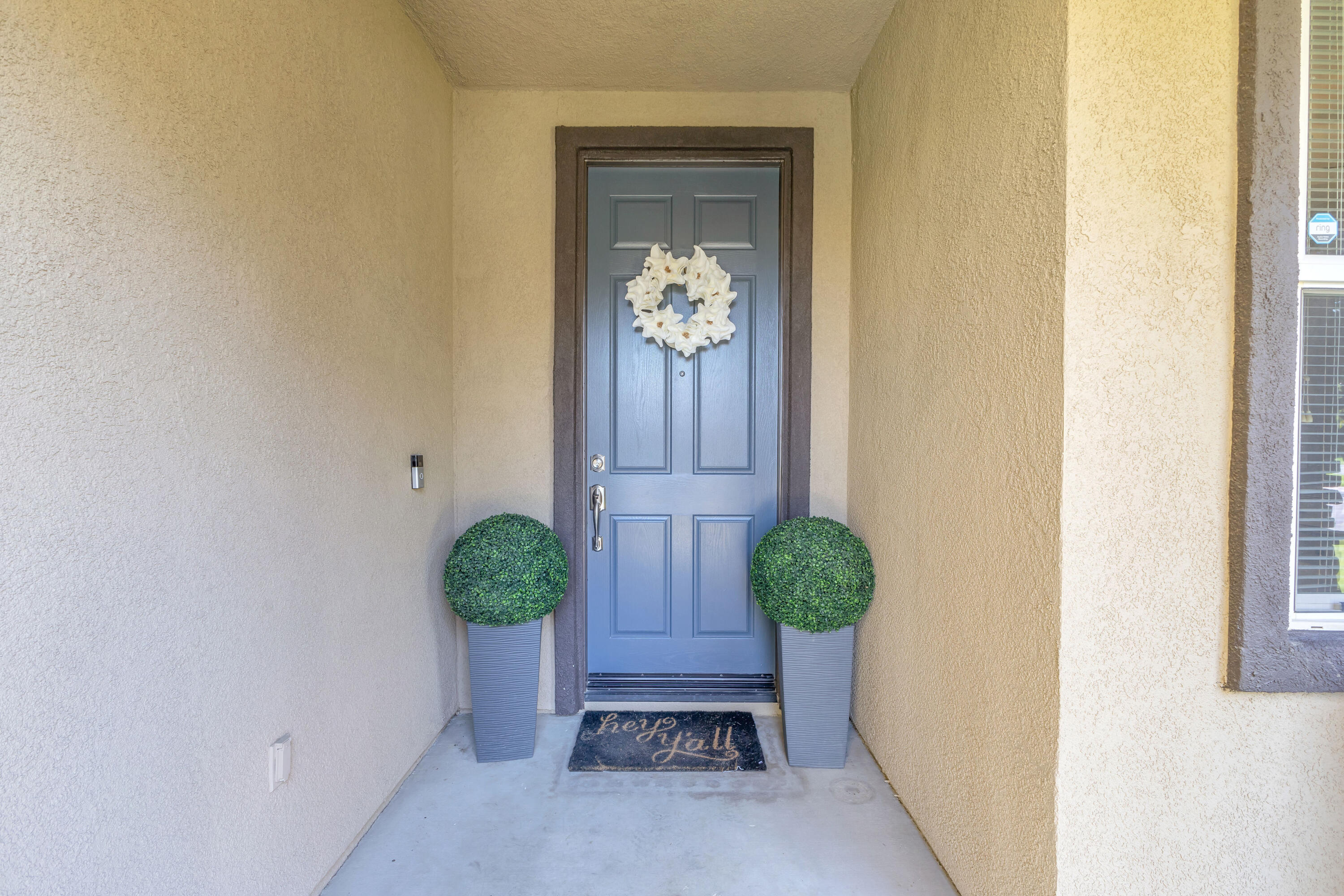 41394 Hanover Street Indio, CA 92203 - Photo 3 of 49 a vase of flowers sitting on a floor in front of a door