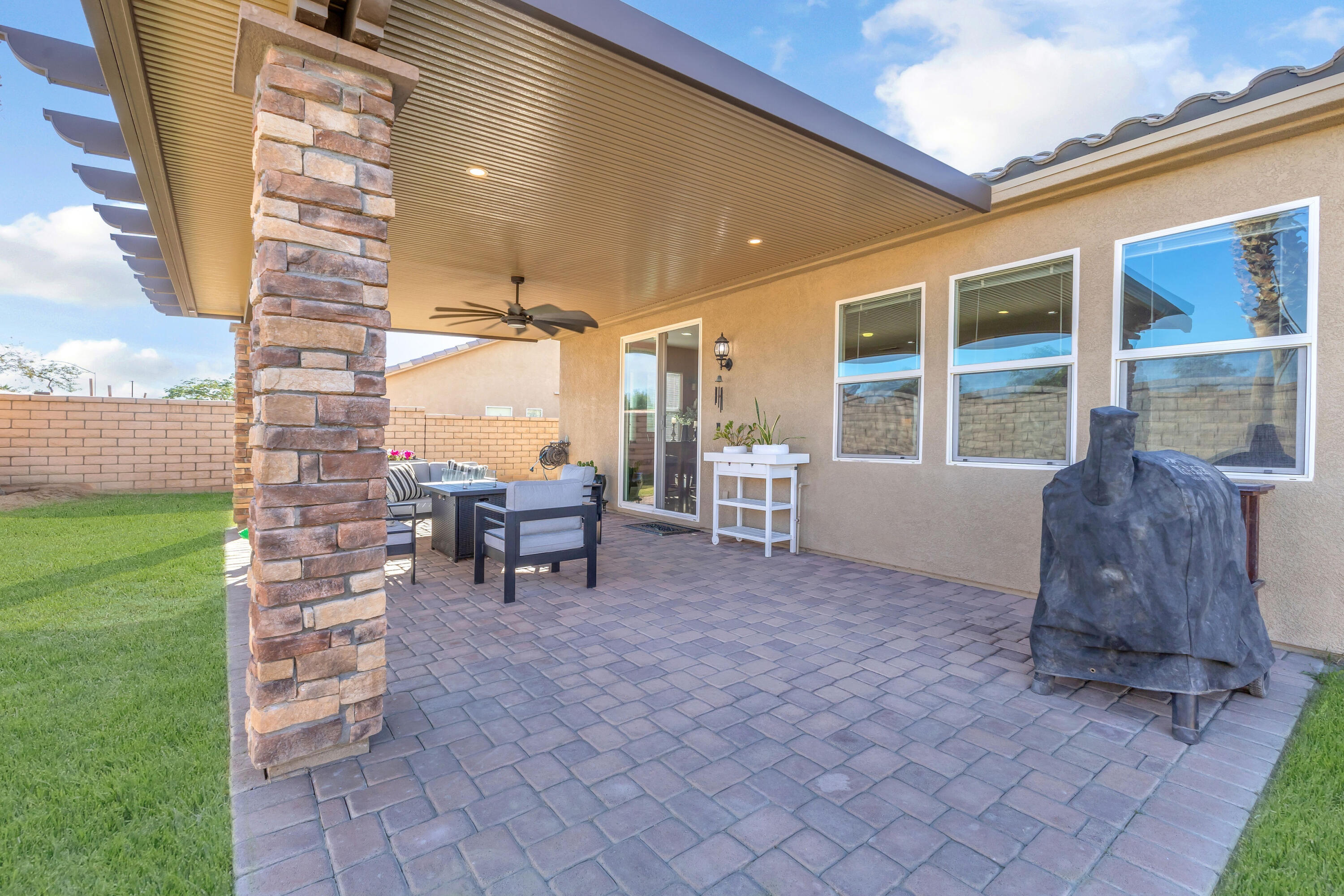 41394 Hanover Street Indio, CA 92203 - Photo 36 of 49 a view of a patio with table and chairs and a barbeque