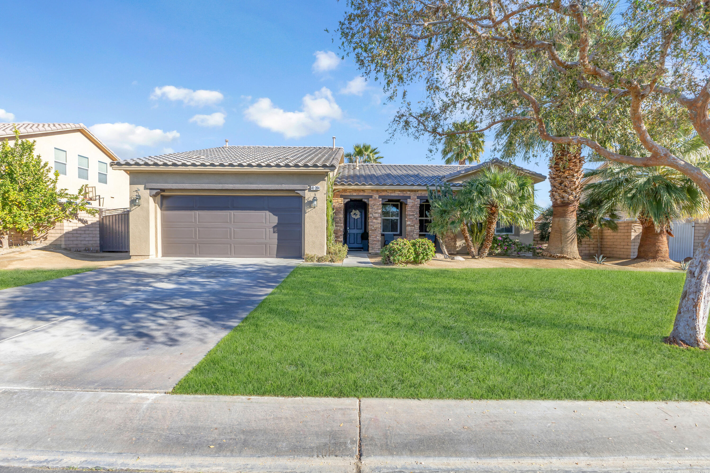 41394 Hanover Street Indio, CA 92203 - Photo 8 of 19 a front view of a house with a yard